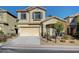 Two-story house with beige exterior, two-car garage, and landscaping at 9104 Little Horse Ave, Las Vegas, NV 89143