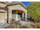 Front porch with decorative metal gate and brick flooring at 9104 Little Horse Ave, Las Vegas, NV 89143