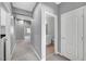 A hallway showcasing grey walls, carpet flooring and a half bathroom at 9104 Little Horse Ave, Las Vegas, NV 89143