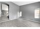 Spacious living room with gray walls and wood-look flooring at 9104 Little Horse Ave, Las Vegas, NV 89143