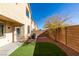 Artificial turf backyard with a small tree and AC units at 9279 Cabin Cove Ave, Las Vegas, NV 89148