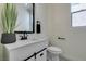 Modern bathroom with white vanity, black accents, and updated fixtures at 9279 Cabin Cove Ave, Las Vegas, NV 89148