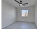 Well-lit bedroom featuring a ceiling fan and large window at 9279 Cabin Cove Ave, Las Vegas, NV 89148