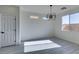 Dining area with grey wood-look floors and modern chandelier at 9279 Cabin Cove Ave, Las Vegas, NV 89148