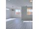 Dining area with grey wood-look floors and a modern chandelier at 9279 Cabin Cove Ave, Las Vegas, NV 89148