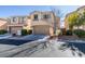 Two-story house with tan siding, attached garage, and landscaping at 9279 Cabin Cove Ave, Las Vegas, NV 89148