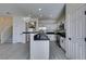 Modern kitchen features white cabinets, black countertops, stainless steel appliances and breakfast bar at 9279 Cabin Cove Ave, Las Vegas, NV 89148