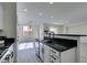 Modern kitchen with white cabinets, black countertops and stainless steel appliances at 9279 Cabin Cove Ave, Las Vegas, NV 89148