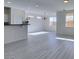 Bright and spacious living room with grey wood-look floors and lots of natural light at 9279 Cabin Cove Ave, Las Vegas, NV 89148