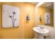 Small bathroom with pedestal sink and yellow walls at 9315 Jade Mesa St # Lot 62, Las Vegas, NV 89139