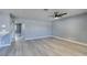 Spacious living room with grey walls, wood-look floors, and ceiling fan at 936 Boulder Mesa Dr # 201, Las Vegas, NV 89128