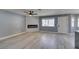 Living room with fireplace, wood-look floors, and door to outside at 936 Boulder Mesa Dr # 201, Las Vegas, NV 89128