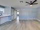 Living room with grey walls, wood-look floors, and ceiling fan at 936 Boulder Mesa Dr # 201, Las Vegas, NV 89128