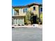 Tan two-story townhome with a private balcony and attached garage at 965 Nevada State Dr # 1202, Henderson, NV 89002