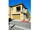 Tan two-story townhome with attached garage and additional parking at 965 Nevada State Dr # 1202, Henderson, NV 89002