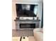 Modern fireplace with stone surround and built-in shelving for decor at 965 Nevada State Dr # 1202, Henderson, NV 89002