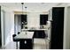 Sleek kitchen with dark cabinetry, a stainless steel refrigerator, and island seating at 965 Nevada State Dr # 1202, Henderson, NV 89002