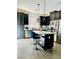 Stylish kitchen featuring a central island, dark cabinets, and stainless steel appliances at 965 Nevada State Dr # 1202, Henderson, NV 89002