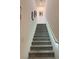 Carpeted staircase with a modern handrail and ample lighting at 965 Nevada State Dr # 1202, Henderson, NV 89002