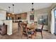 Bright dining room with hardwood floors and kitchen view at 9916 Fallowdeer Ct, Las Vegas, NV 89149