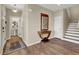 Elegant entryway with hardwood floors, a half bathroom, and a modern console table at 9916 Fallowdeer Ct, Las Vegas, NV 89149