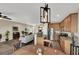 Open concept kitchen and dining area with stainless steel appliances and light wood cabinets at 9916 Fallowdeer Ct, Las Vegas, NV 89149