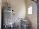 Laundry room with water heater and water softener system at 9916 Fallowdeer Ct, Las Vegas, NV 89149