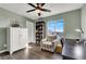 Home office with built-in bookcase and comfortable chair at 9916 Fallowdeer Ct, Las Vegas, NV 89149