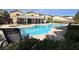 Community pool with lounge chairs and covered seating at 9916 Fallowdeer Ct, Las Vegas, NV 89149