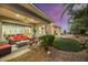 Expansive backyard with covered patio, hot tub, and lush landscaping at 10275 Tresor Ct, Las Vegas, NV 89135