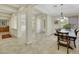 Formal dining room with a dark wood table and chandelier at 10275 Tresor Ct, Las Vegas, NV 89135