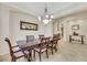 Elegant dining room featuring a large table, chandelier, and hardwood floors at 10275 Tresor Ct, Las Vegas, NV 89135