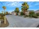 Two-story house with a two car garage and palm trees at 10275 Tresor Ct, Las Vegas, NV 89135