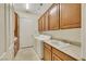 Laundry room with washer, dryer, cabinets, and sink at 10275 Tresor Ct, Las Vegas, NV 89135