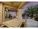 Spacious covered patio with seating area and views of the backyard at 10275 Tresor Ct, Las Vegas, NV 89135