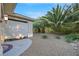 Private patio area with gravel landscaping and privacy screen at 10275 Tresor Ct, Las Vegas, NV 89135