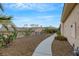 Paved walkway with desert landscaping alongside a building at 10275 Tresor Ct, Las Vegas, NV 89135