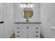 Modern bathroom with a white vanity and round mirror at 1208 Clairemont St, Las Vegas, NV 89110