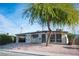 Mid-century modern home with carport and mature tree at 1208 Clairemont St, Las Vegas, NV 89110