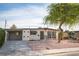 Mid-century modern home with carport and mature tree at 1208 Clairemont St, Las Vegas, NV 89110