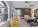 Stylish bedroom with wood floors, yellow armchairs, and a large window at 1610 Hardrock St, Las Vegas, NV 89156