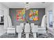 Modern dining room with white chairs and colorful artwork at 1610 Hardrock St, Las Vegas, NV 89156