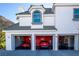 Three-car garage with red walls and ample storage at 1610 Hardrock St, Las Vegas, NV 89156