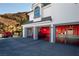 Extravagant three-car garage with red walls and car lifts at 1610 Hardrock St, Las Vegas, NV 89156