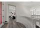 Elegant hallway with curved staircase and modern light fixture at 1610 Hardrock St, Las Vegas, NV 89156