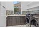 Convenient laundry room with modern washer, dryer, and cabinets at 1610 Hardrock St, Las Vegas, NV 89156