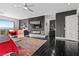 Main bedroom with a large TV, fireplace, and red chairs at 1610 Hardrock St, Las Vegas, NV 89156