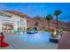 Expansive pool and patio area with fire features and mountain backdrop at 1610 Hardrock St, Las Vegas, NV 89156