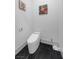 Modern powder room with a smart toilet and black tile floor at 1610 Hardrock St, Las Vegas, NV 89156