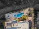 Drone shot showing the home with an in-ground pool and an outdoor deck for seating at 1635 Liege Dr, Henderson, NV 89012